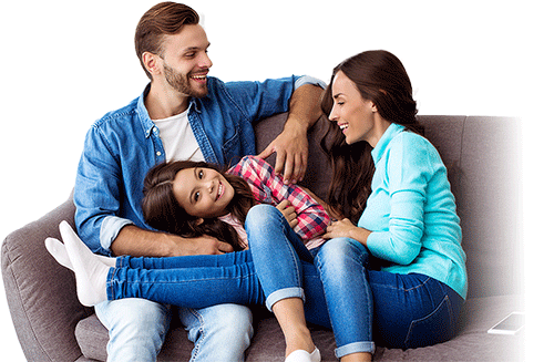Happy family relaxing on a couch, enjoying comfortable indoor air quality provided by professional HVAC contractor services.
