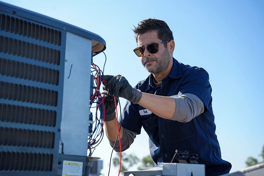 Rolando's HVAC technician performing an HVAC replacement